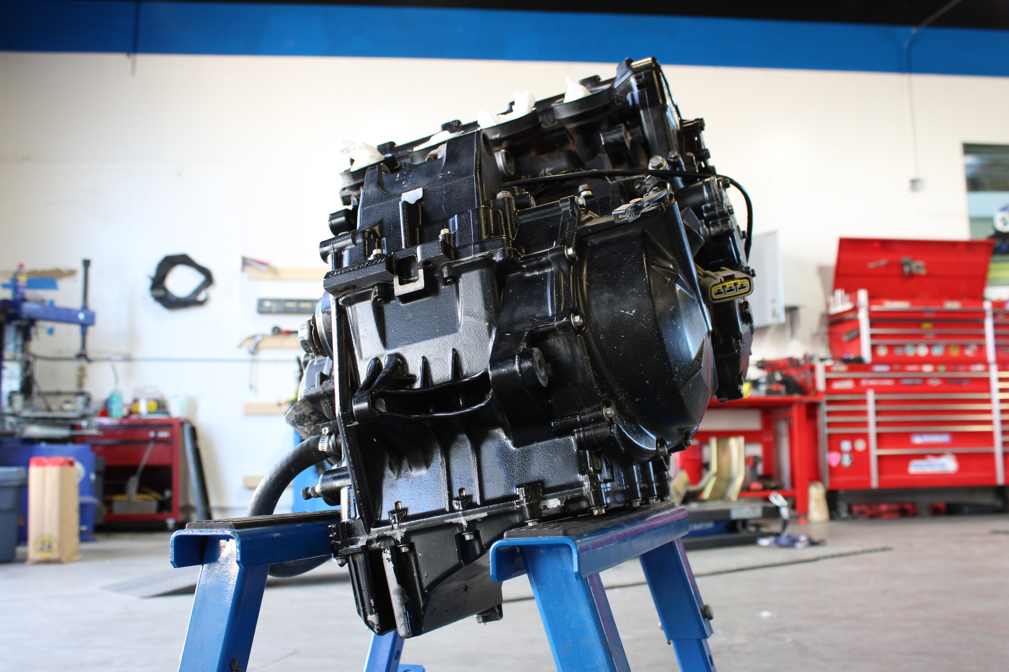 Motorcycle engine on a blue dolly in the shop
