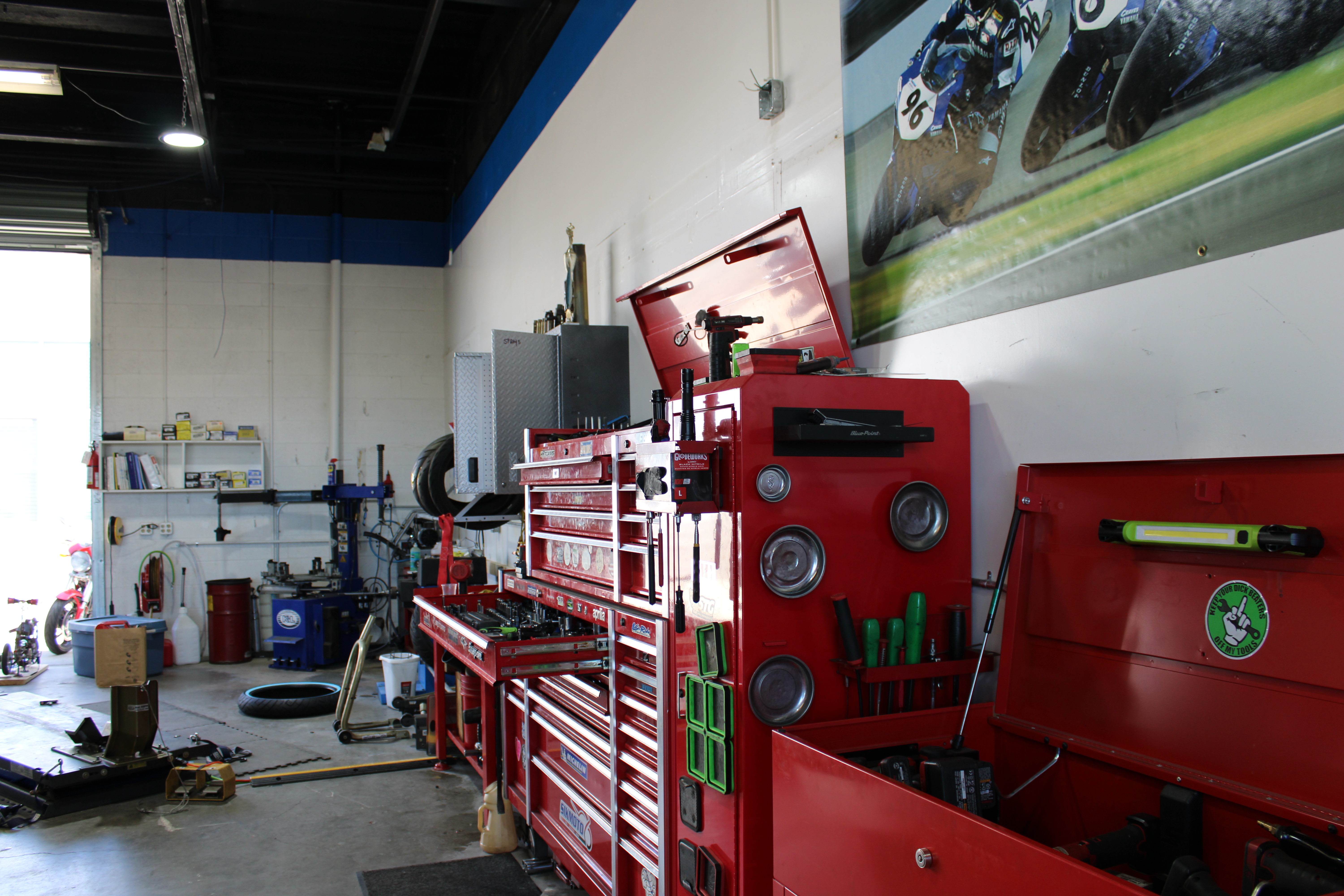 Motorcycle engine on a blue dolly in the shop