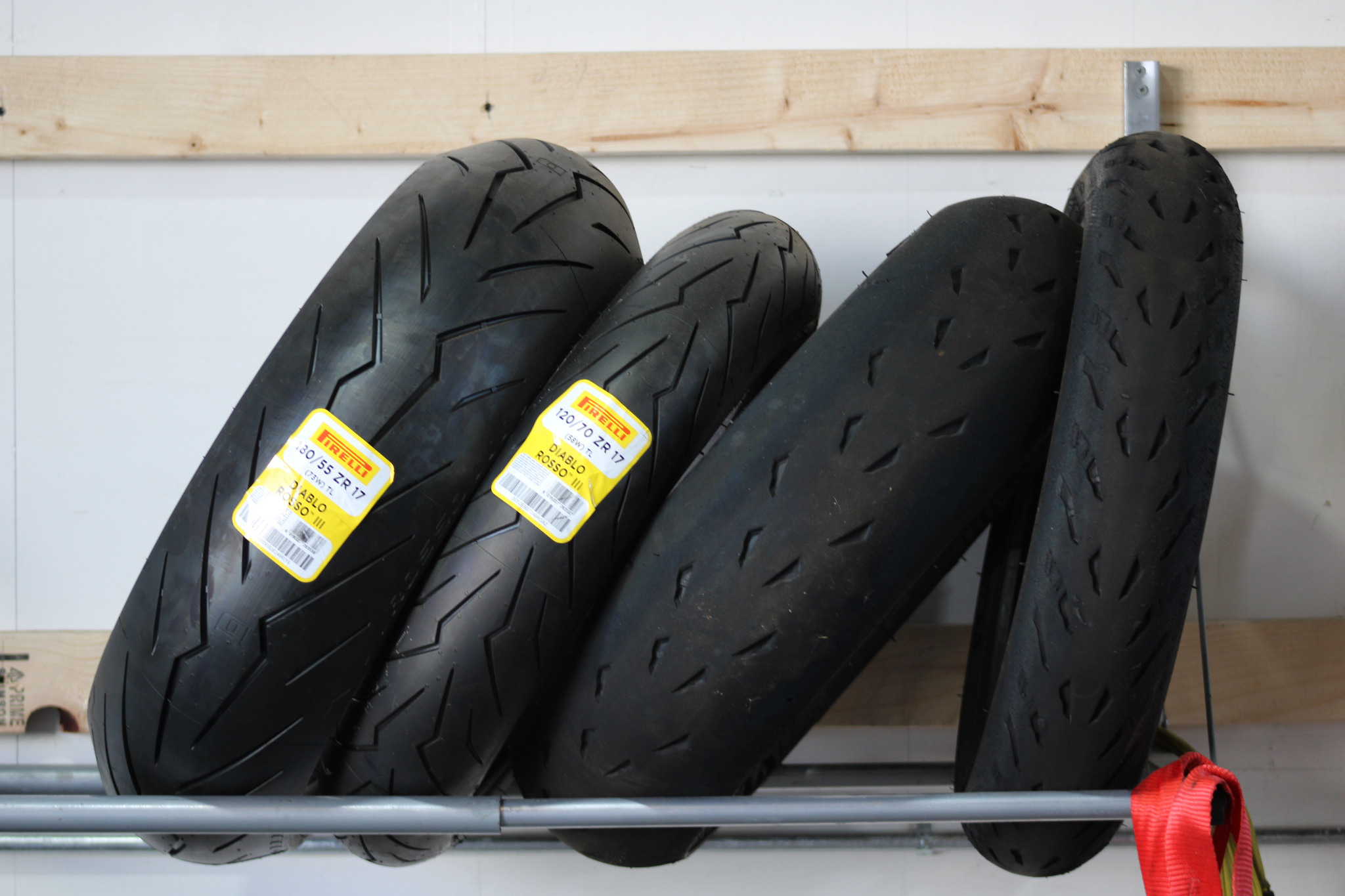 Motorcycle tires stored on a wall rack